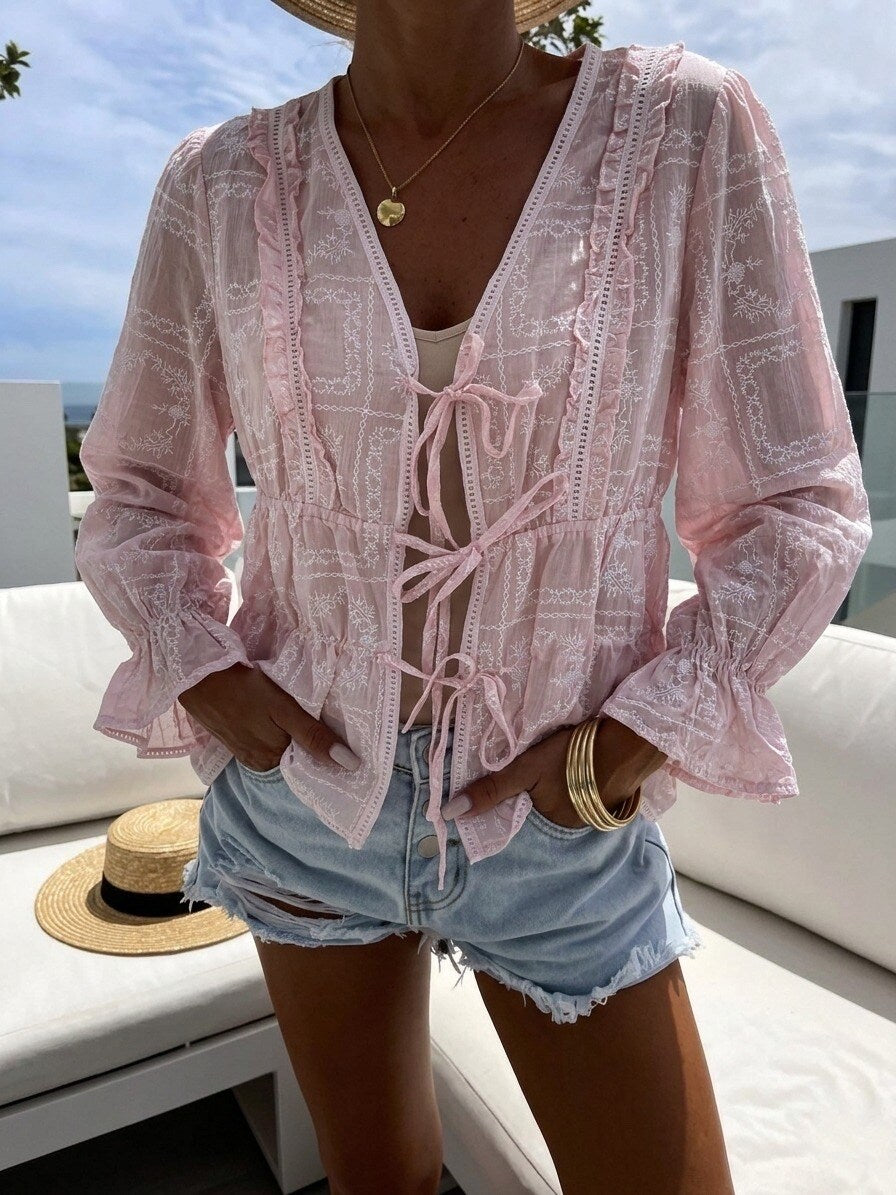 Bluse mit Muster und Schleifen rosa